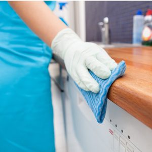 Woman Cleaning Kitchen Countertop